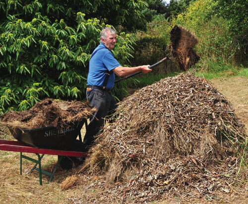 Garden expert Peter Cundall builds a leafmould mound.