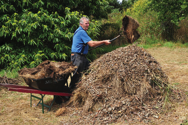 Garden expert Peter Cundall builds a leafmould mound.