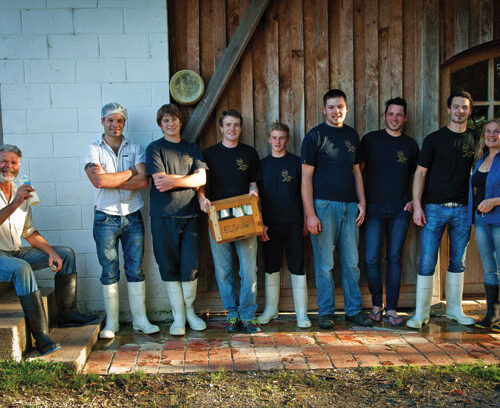 Joe (far left) and Antonia (far right) with four of their sons and three apprentices.