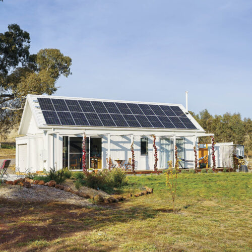 An off-grid house with solar panels covering the roof.