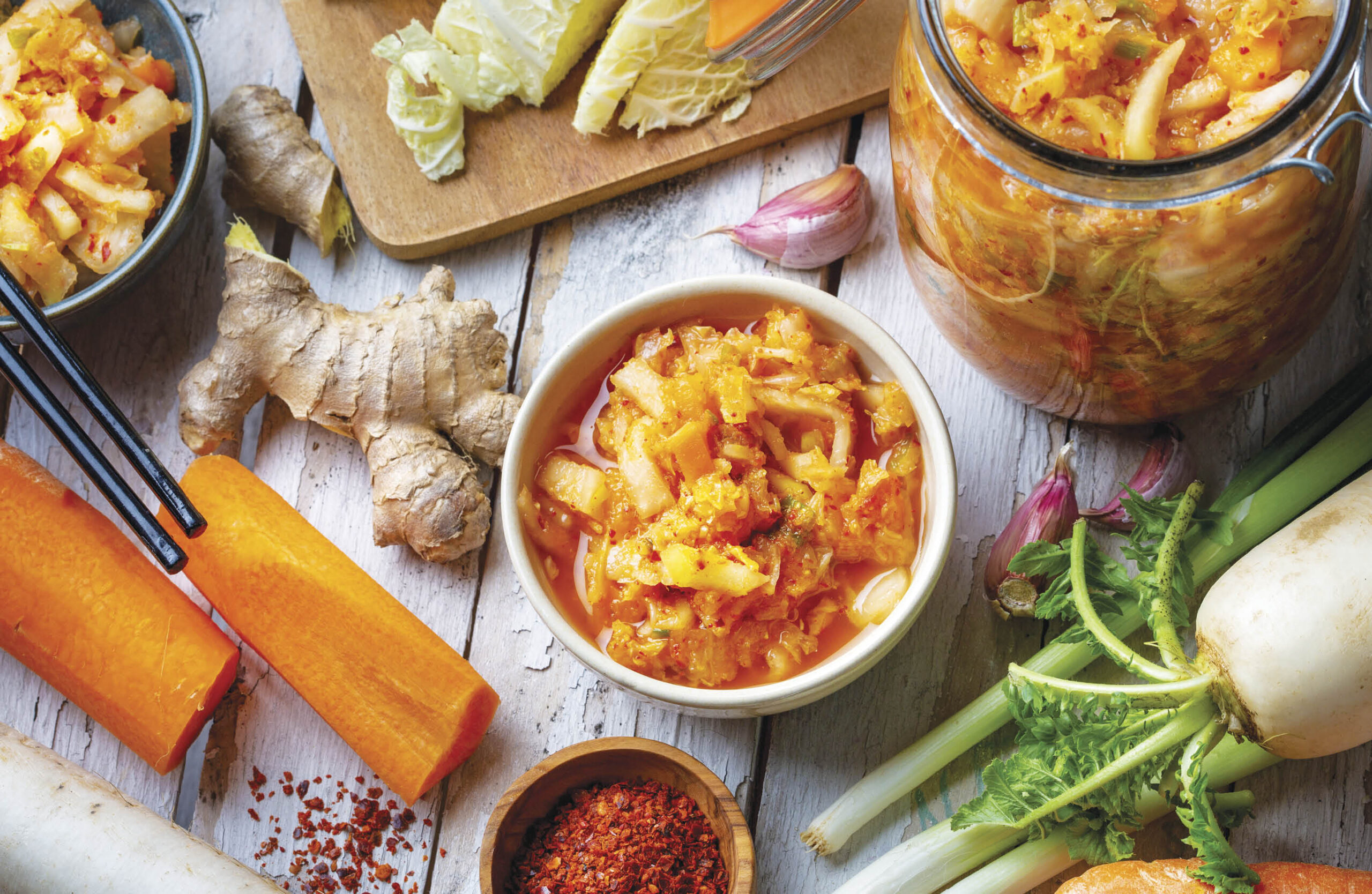 Ingredients to make kimchi and a bowl full of kimchi.